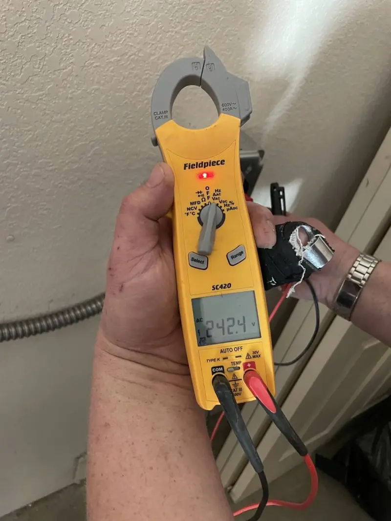 Voltage testing with clamp meter during Outlet Installation in Woodstock